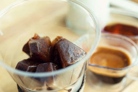 Ice  coffee and Coffee and syrup on a wooden table in a coffee shop.の写真素材