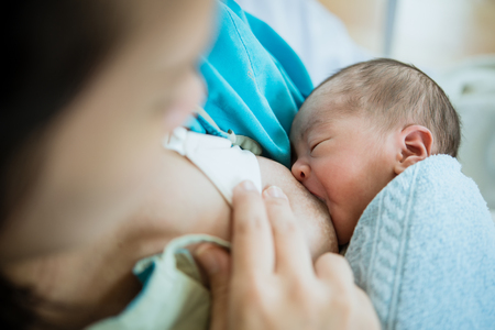 Asian women are breast-feeding newborn son with loveの写真素材