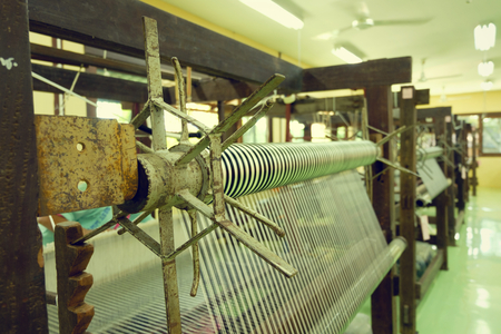 Traditional weaving machines used in the textile industry.
