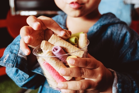 asia Children eating  Tootsie Dessert colorfulの写真素材