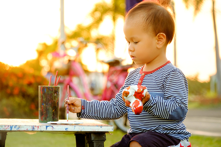 child  painting color drawing at public park is sunsetの写真素材