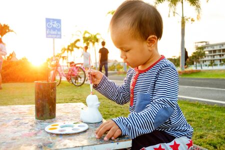 child  painting color drawing at public park is sunsetの写真素材