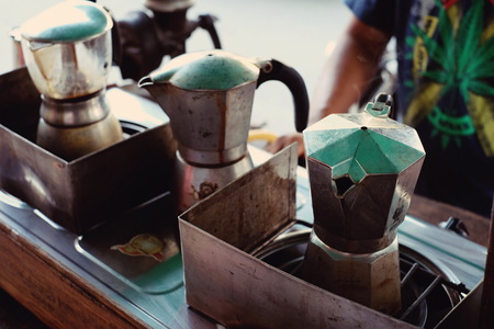 moka pot Italian traditional coffee maker with hot coffee,making coffee in moka potの写真素材