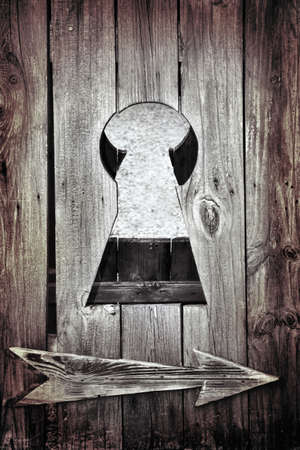 keyhole and an arrow on the old doorの写真素材