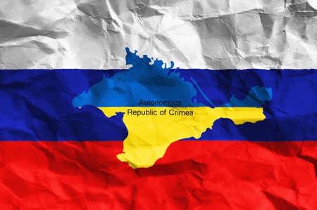 Ukraine crisis  Crimea votes to join Russia, the map of Crimea at the flag of Russia on creased paperの写真素材