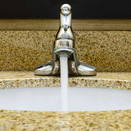 Faucet with waterの写真素材