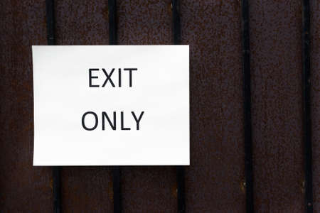 Exit Only Sign on a wood wall