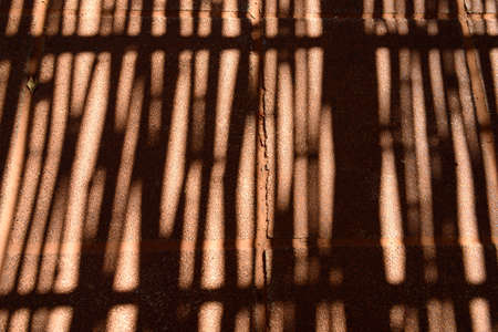 Shadow of bamboo fence on a floorの写真素材