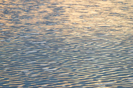 Water wave reflection with sunの写真素材