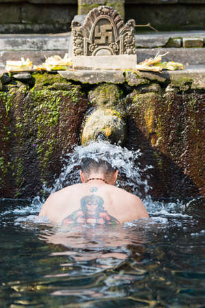 People pray at Tirta Empul Holy Water Templeの写真素材