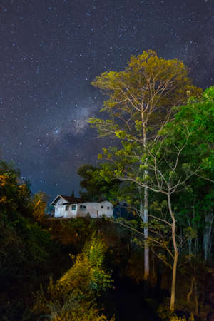 Milky way, house and treesの写真素材