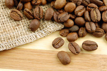 Coffee beans on sacking bag on desk with place for you text.