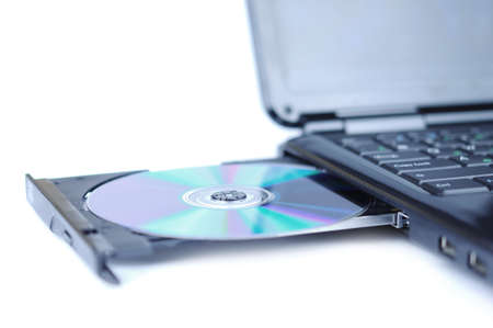 Laptop with a disk dvd in the tray の写真素材