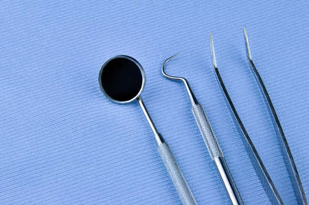 Dental tools on a blue background. Dental treatment.