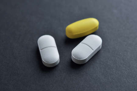 Three Tablets on black background. Medication concept.の写真素材