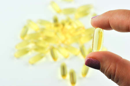 Vitamins. Closeup Of Girl holding Pill With Fish Oil Omega-3. Nutrition. Healthy Nutritional...