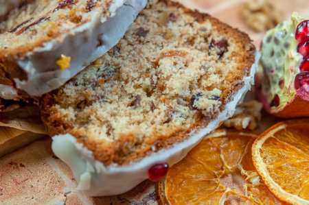 Christmas stollen with candied fruit and dried fruits on parchment. Stollen - traditional German...