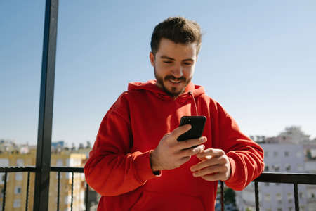 Phone calling, handsome young man talking on the phone. interacting with happy-looking adult people