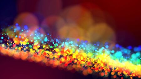 a cloud of multicolored particles in the air like sparkles on a dark background with a small depth of field. beautiful bokeh light effects with colored particles. background for holiday presentationsの写真素材