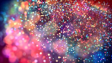 a cloud of multicolored particles in the air like sparkles on a dark background with a small depth of field. beautiful bokeh light effects with colored particles. background for holiday presentationsの写真素材