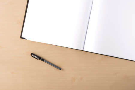 White blank artbook on the table with penの写真素材