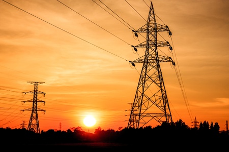 Electricity pylons at sunset by sumitの写真素材
