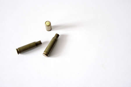 patron and cartridge cases on white background