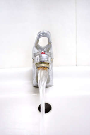 water flows from faucet and toothbrush with hygiene by paste for cleaning teethの写真素材