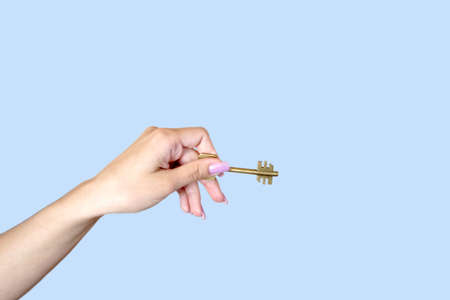 feminine hand keeps keyの写真素材