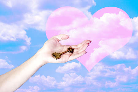 hand with key and rose heart on celestial backgroundの写真素材