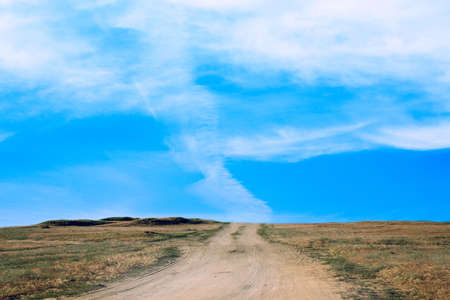 clouds on blue sky on empty rural roadの写真素材