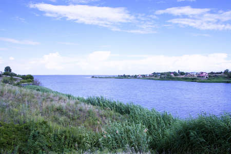 year evening on blue river and green hillの写真素材