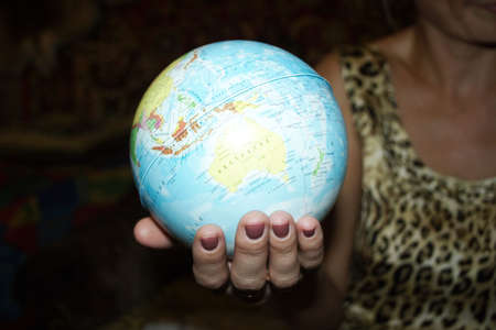 abstract scene globe in feminine handの写真素材