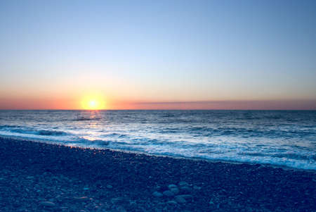 abstract scene with beautiful year sundown sun on sea beachの写真素材