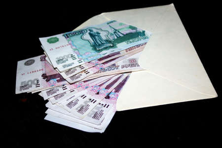 several paper money bills in white clean envelopeの写真素材