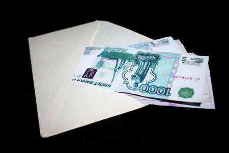 several paper money bills in white clean envelopeの写真素材