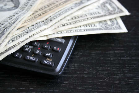 paper dollar bills resting upon dark backgroundの写真素材