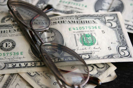 paper dollar bills and spectacles for correcting the visionの写真素材