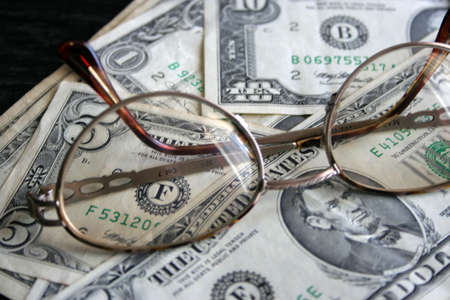paper dollar bills and spectacles for correcting the visionの写真素材