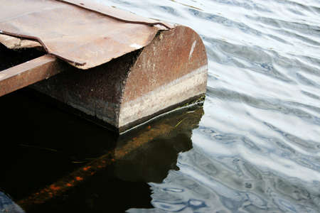 rusty old metallic quay on riverの写真素材