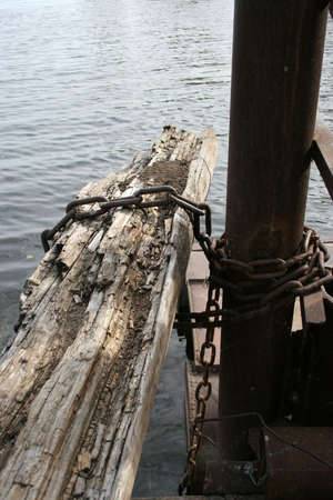 rusty chain on river pierの写真素材