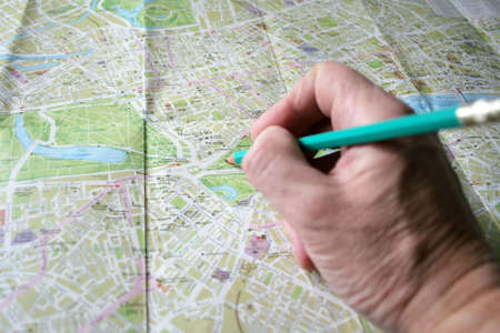 hand with pencil and geographical card to terrainの写真素材
