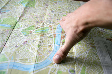 hand with pencil and geographical card to terrainの写真素材