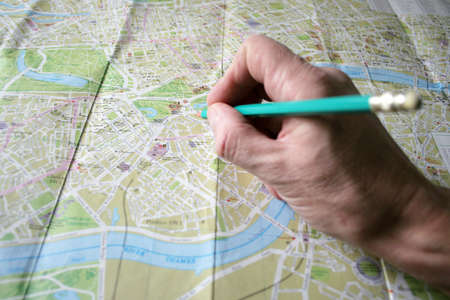 hand with pencil and geographical card to terrainの写真素材