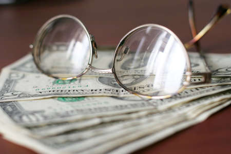 small amount of the dollars and spectacles of the old personの写真素材