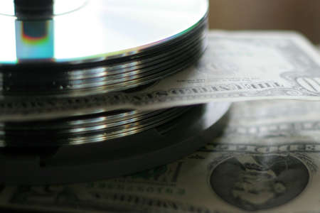 small quantity of the small bills of the dollars and computer diskの写真素材