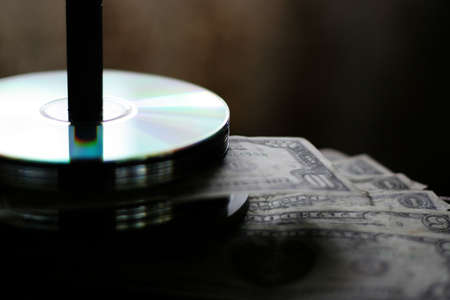 small quantity of the small bills of the dollars and computer diskの写真素材