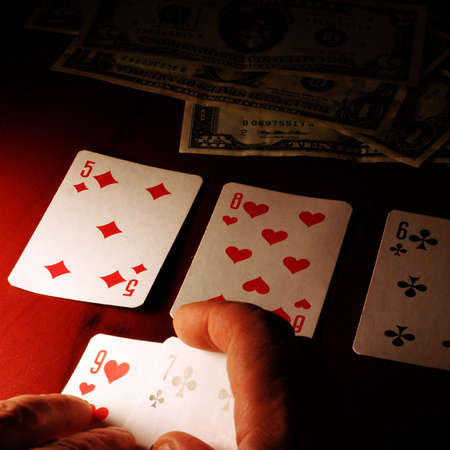 playing cards in hand of the player in poker
