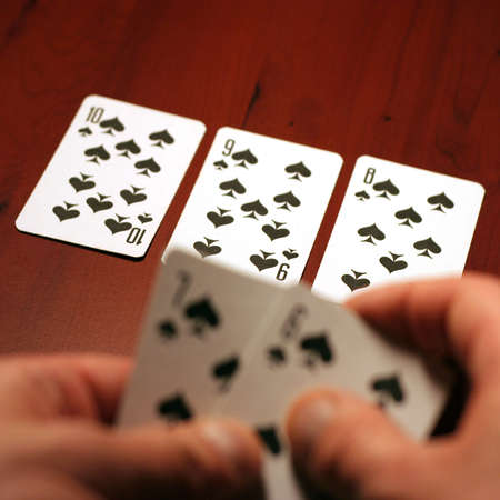 playing cards in hand of the player in poker