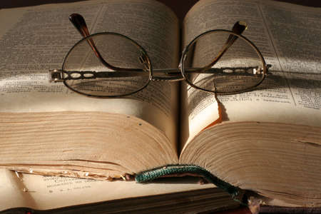 pages aging book and spectacles for correcting the vision